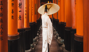 Corridor filled with pillars and an oriental monk in the middle